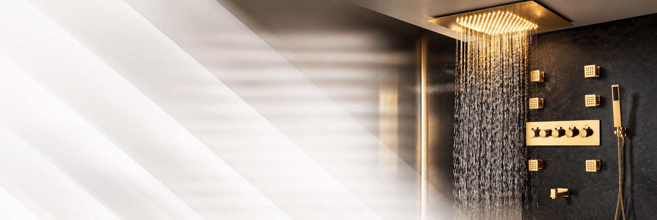BathSelect brushed gold LED waterfall and rainfall shower system with body jets and handheld sprayer